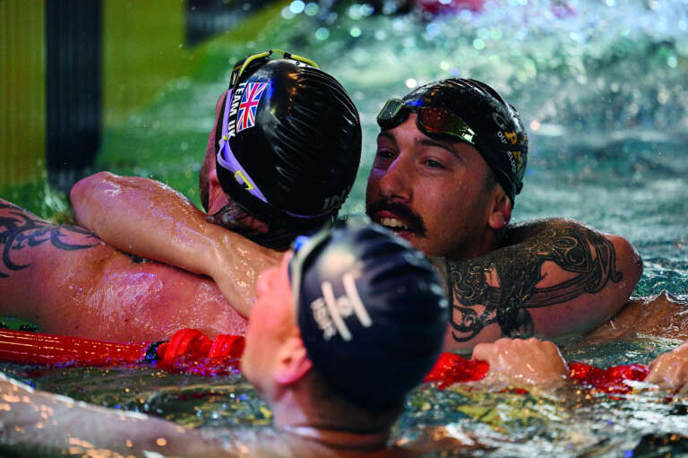 Zwemmers die elkaar omhelzen bij Invictus Games in Düsseldorf door OVAL.